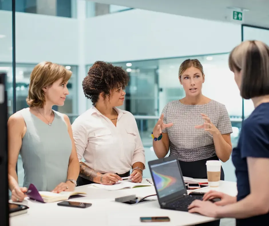 Women discussing ideas around a table